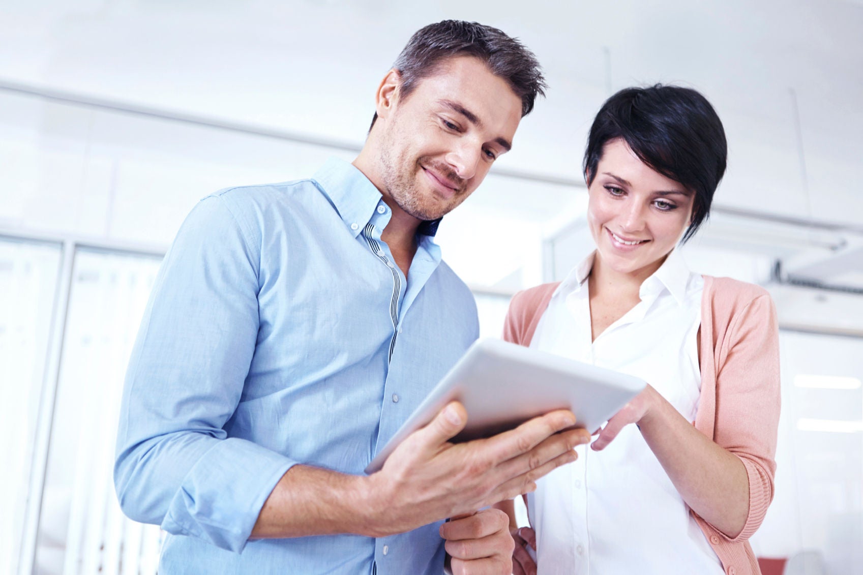 POE_Staff_ISTOCK_000032556618_MEDIUM.JPG Two businesspeople standing together in the office and looking at a digital tablet